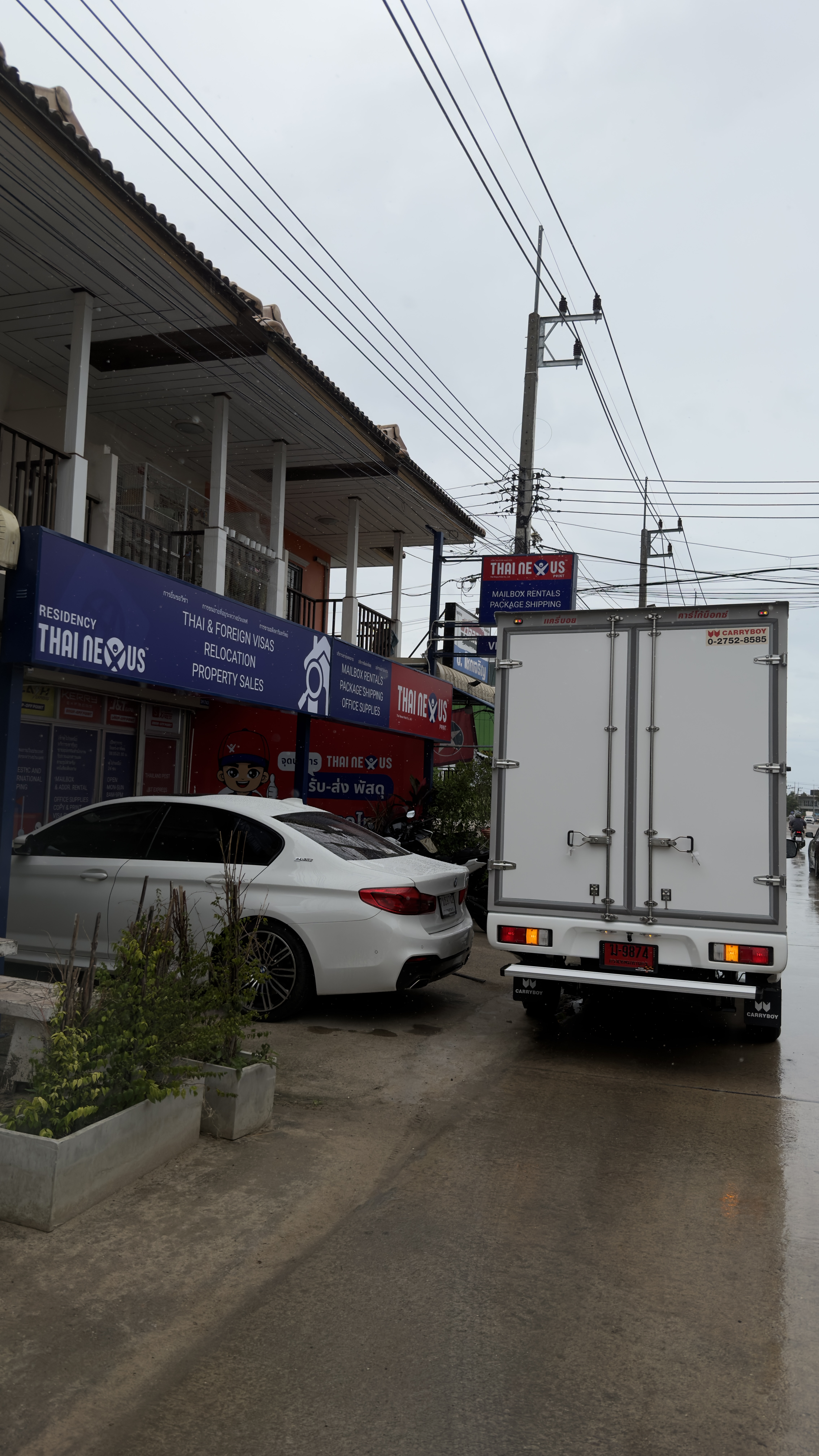 Thai Nexus Point international shipping office signage at the Hua Hin HQ service counter